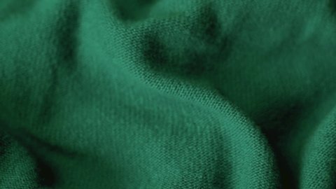 Detailed Texture of Woolen Knitted Green Fabric, Closeup. Cozy Wool Blanket, Bedspread, Textile, Thin Yarn, Warm Sweater. Green Fabric Background. Factory Store Woolen Products.