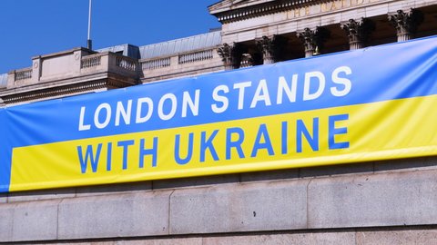 London, UK, March 26th 2022: A London stands with Ukraine blue and yellow flag banner. In Trafalgar Square, for support the solidarity march and vigil. Support Ukraine people, stop the war.