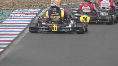 Karts passing in a curve of a circuit in a karting race