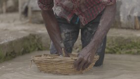 Moonstone mining in sri lanka. Jewelry basket. The traditional process of mining precious stones. Manual washing of the rock in water. Slow motion 120 fps video, ProRes 422, 10 bit, ungraded C-LOG