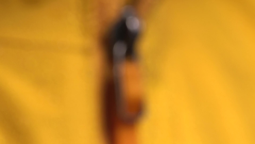 Macro shot of the zipper on the Gore-Tex membrane jacket does not allow moisture to pass through. Slow motion close-up of water drops on the yellow waterproof clothing.
 Royalty-Free Stock Footage #1088753171