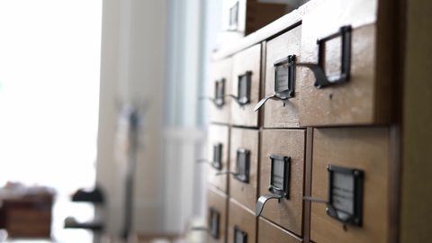 Search for documents in a file cabinet, close-up. Vintage archive. Search by file system.