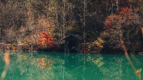 Wide Drone Flight Panning Over Klammsee Reservoir With Wooden Boathouse In Autumn, Kaprun, Salzburg, Austria