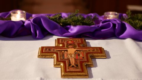 Vohrenbach, Germany - December 19, 2021: Christian cross with Jesus in the church in Vohrenbach and purple altar decoration in advent time.