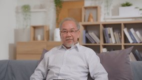 Happy asian old man using smartphone chat with child over a video call in a long distance relationship in virtual app. Smiling older Grandpa talking with his family working abroad. face-to-face talk.