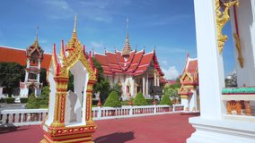 Wat chalong temple popular Phuket Thailand. The most important Thai Buddhist church famous tourist in Thailand. Landscape view walk through entrance to temple daytime. Video dolly 4K. 
