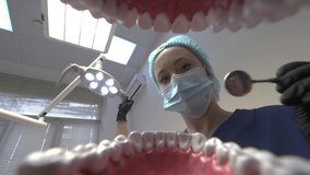 Closeup 4k video from inside of mouth of dentist treating teeth