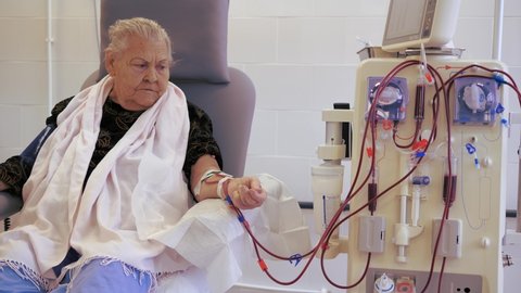 Hardware Hemodialysis. An elderly person, a patient connected to a blood assessment machine.