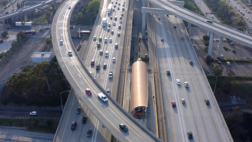 Aerial shot of elevated road junction. Drone footage of top view of Highway road junctions. The Intersecting freeway road overpass. Overhead Shot of Judge Pregerson Highway showing multiple Roads.  Royalty-Free Stock Footage #1088761421
