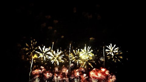 4K. loop seamless of real fireworks background. abstract blur of real golden shining fireworks with bokeh lights in the night sky. glowing fireworks show. New year's eve fireworks celebration.