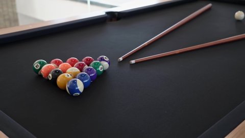 Close-up of a billiard table with balls and cue for gambling indoors. Table game snooker for the entertainment of tourists