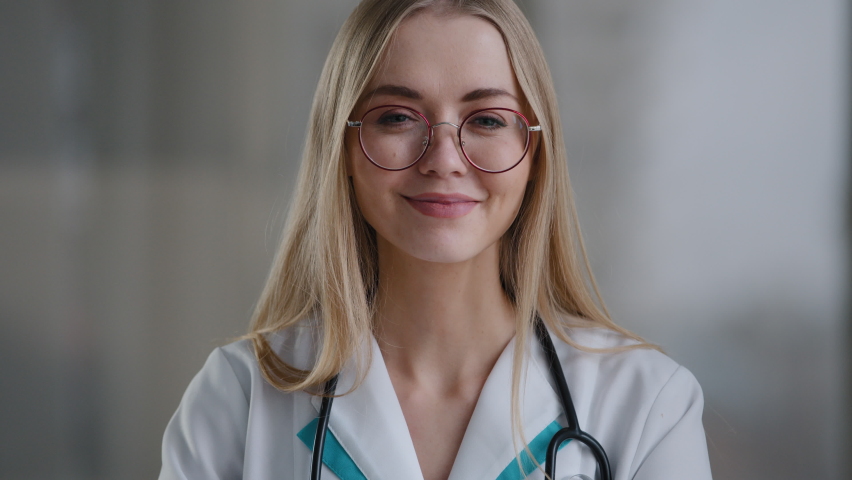 Portrait caucasian happy successful doctor practitioner specialist therapist nurse medical worker woman in glasses looking at camera shows ok gesture recommends good health healthcare fine well great Royalty-Free Stock Footage #1088764471