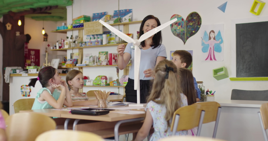 Elementary School Stem Robotics Classroom Diverse Group of Children Building and Programming windmill ecology robot concept. Together Talking and Working as a Team. Creative Robotics Engineering