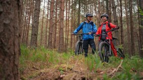 Senior couple bikers outdoors in forest in autumn day. - Powered by Shutterstock - Get 15% off with code: PIKWIZARD15