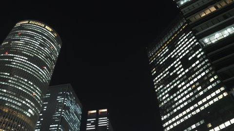 Nagoya.Japan-October 31.2019: Skyscrapers in the downtown of Nagoya in Japan at nighttime. Busy metropolitan life concept. Beautiful cityscape. Camera slowly turning left.