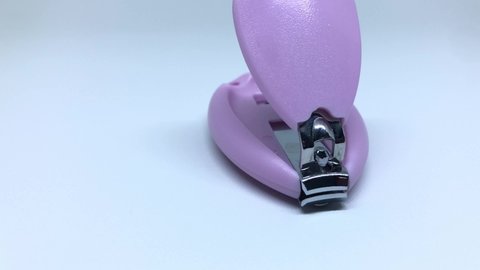 purple baby nail clipper with out of focus object