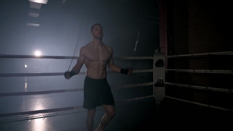 Boxer jumping rope in boxing ring. High quality 4k footage