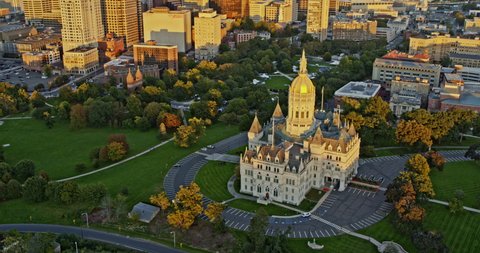 Hartford Connecticut Aerial v16 birds eye view overlooking at golden sunset reflection on state capitol building and downtown high rise cityscape - Shot with Inspire 2, X7 camera - October 2021