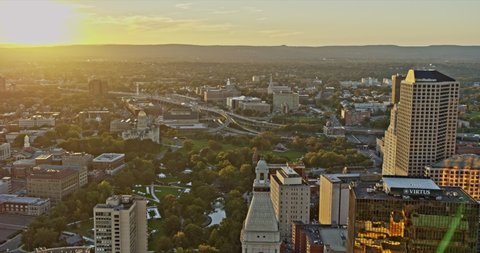 Hartford Connecticut Aerial v10 drone fly around downtown capturing spectacular cityscape with shimmering sunset reflection on high rise glass windows - Shot with Inspire 2, X7 camera - October 2021