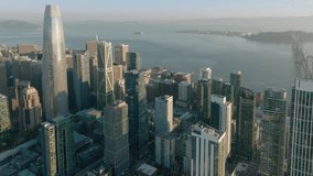 San Francisco California USA aerial drone footage of harbor piers with Downtown skyscrapers and bay on cinematic background. Financial and residential buildings cityscape view on sunny summer day, 4K