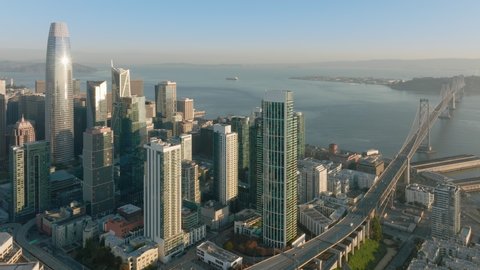 San Francisco California USA aerial drone footage of harbor piers with Downtown skyscrapers and bay on cinematic background. Financial and residential buildings cityscape view on sunny summer day, 4K