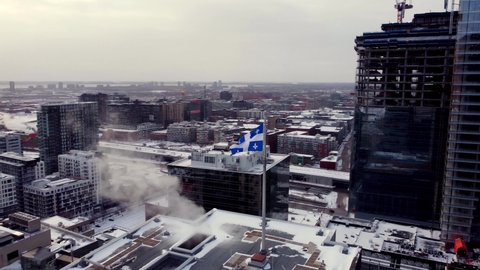 B-Roll Drone shot Quebec flag downtown Montreal during winter.
