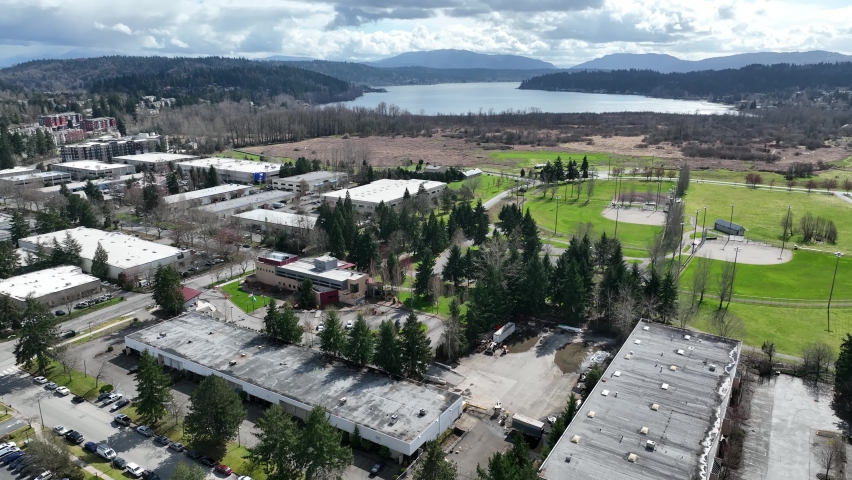 Cinematic aerial drone footage of Marymoor Park by Lake Sammamish near Redmond Town Center mall, WA-520 in Redmond, Washington, King County