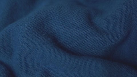 Woolen Knitted Dark Blue Fabric, Detailed Texture, Close up, Macro. Cozy Wool Blanket, Bedspread, Textile, Thin Yarn, Knit, Warm Sweater. Dark Blue Fabric Background. Factory Shop Woolen Products.