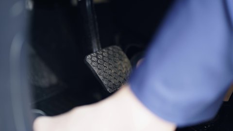 Accelerator and breaking pedal in a car. Close up the foot pressing foot pedal of a car to drive ahead. Driver driving the car by pushing accelerator pedals of the car. Inside vehicle.