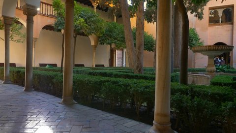 Moorish courtyard in Alhambra Palace in Granada, Spain. Inner courtyard with trees and fountain in Alhambra Palace, Granada, Andalusia. Gimbal shot, 4K. High quality 4k footage