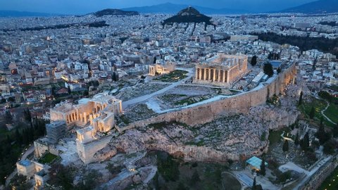 night view of Acropolis in Athens, flying above illuminated Parthenon in Athens in the evening, night view of downtown Athens, international landmark in Greece. High quality 4k footage
