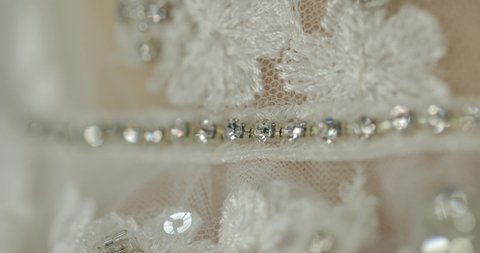 handmade, wedding dress corset sash, focus on the beads that glitter. production of wedding dresses. macro