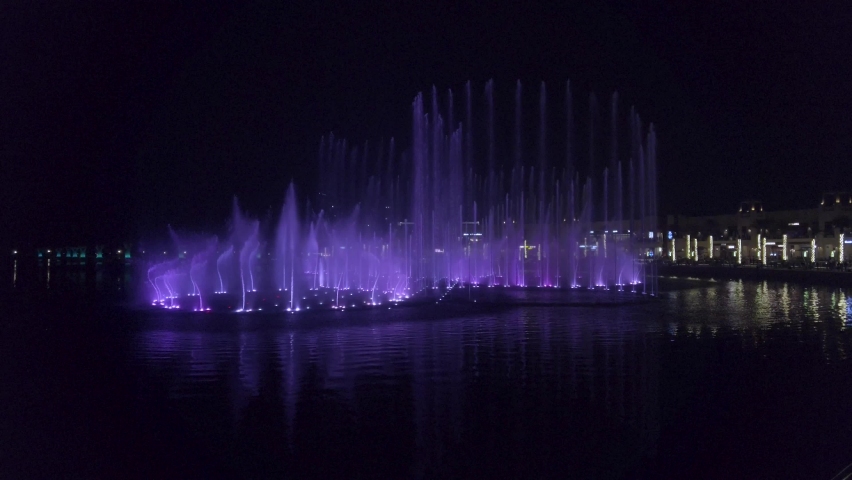 Music and lights fountain show at the Palm Dubai manmade island in Dubai, United Arab Emirates. 4k footage. Largest fountain in the world.