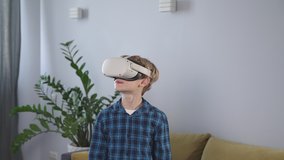 Boy playing games with VR headset. Enjoying time at home. Experiencing virtual reality. Kid wearing VR headset, moving hands and touching air. Digital education or virtual reality learning - Powered by Shutterstock - Get 15% off with code: PIKWIZARD15