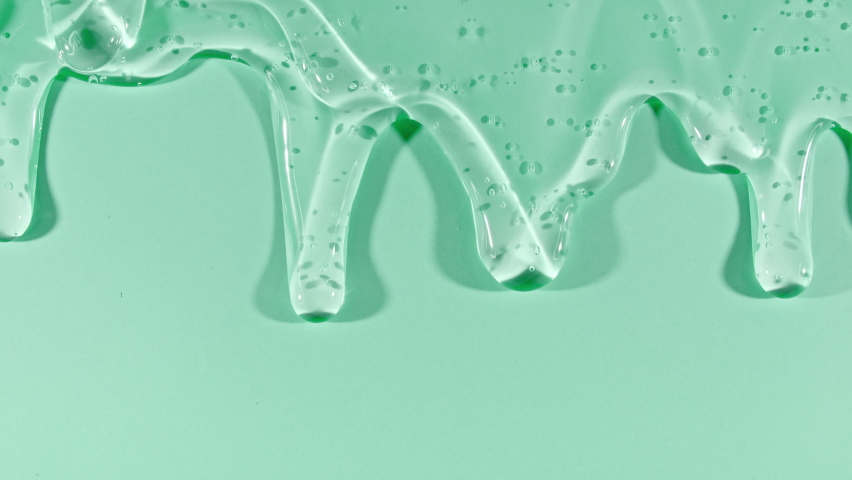 Transparent Cosmetic Gel Fluid With Molecule Bubbles Flowing On The Green Surface. Macro Shot of Natural Organic Cosmetics, Medicine. Production Close-up. Slow Motion | Shutterstock HD Video #1088789959