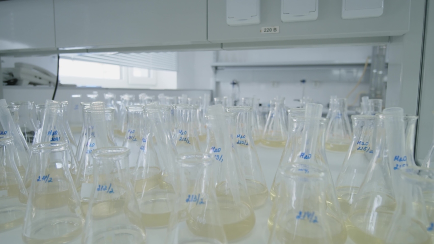 Medical And Chemical Flasks With Yellow Liquids Inside 