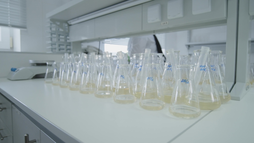 Chemical Laboratory Glassware With Yellow Liquids Inside on the bright background