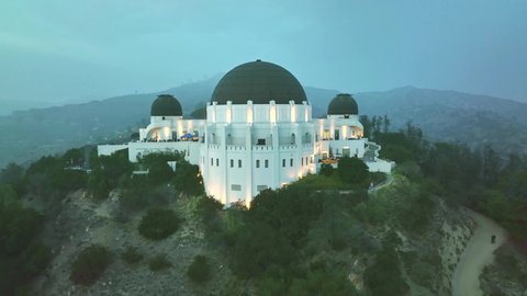 LOS ANGELES, CA, USA - March 15, 2022: Drone aerial shot 4k. Griffith observatory. Los Angeles skyline at night. California landmark, travel destination in America. popular tourist city in USA.