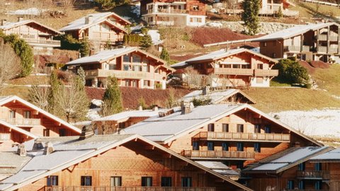 Chalets and houses in a sunny alpine ski resort, France