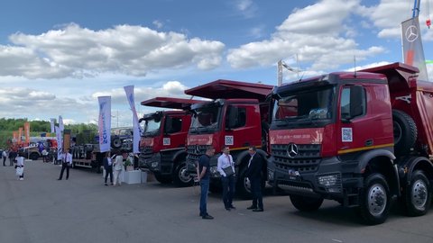 Dump trucks Mercedes-Benz Arocs at the Bauma CCT Russia 2021 construction industry fair. A row of new tipper trucks for construction works. Moscow, Russia - May 25-28, 2021
