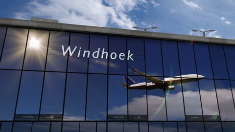 Plane landing at Windhoek, Namibia 3D rendering animation. Arrival in the city with the glass airport terminal and reflection of the jet aircraft. Travel, business, tourism and transport concept.