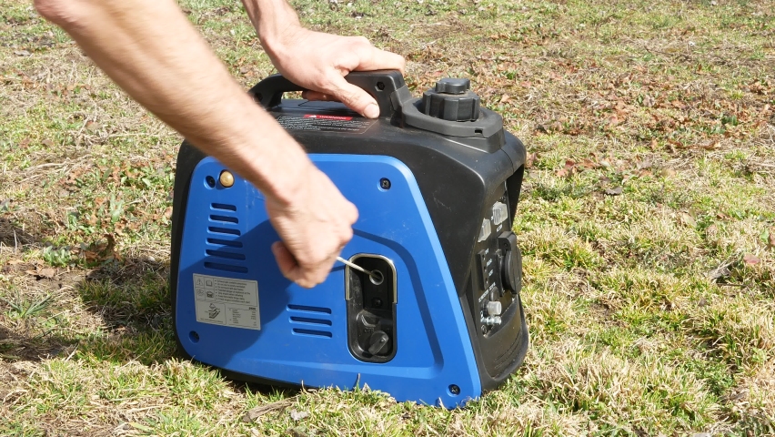 A man starts a gasoline generator with a starter cord. Royalty-Free Stock Footage #1088803343