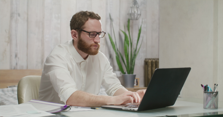 Stressed young man in glasses suffering from muscles tension, having painful head feelings due to computer overwork or sedentary working lifestyle. Royalty-Free Stock Footage #1088804807