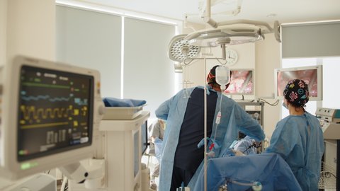 Operation using laparoscopic equipment. Process of gynecological surgery operation using laparoscopic equipment. Group of doctor in operation room for laparoscopic.