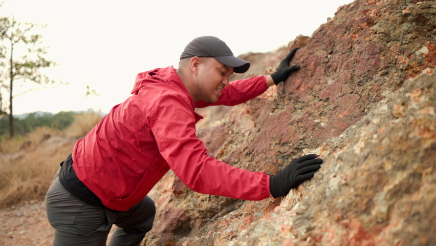 Climber man challenge for purpose hiking on rocky mountains at vacations outdoor. Man traveler mountaineering on adventure trip at holidays. Travel lifestyle concept.