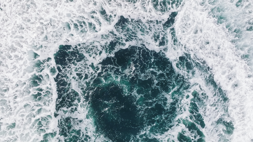 Aerial epic shot of jet ski racing on deep blue green clear sea waters. Adult male enjoying summer vacation speeding on a jet ski. Water sports, extreme, joy and positive emotions concept footage