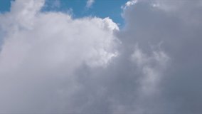 Flying through fluffy white clouds in clear blue sky. Cumulus white cloud cloudscape, summer blue sky time lapse. Nature weather blue sky background. Cloud time lapse nature background 4K aerial