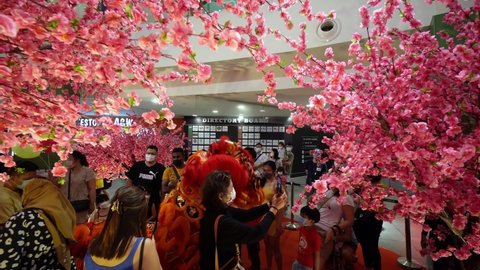 Georgetown, Penang, Malaysia - Feb 05 2022: A woman selfie with lion dance at decoration of plum blossom decoration during Chinese New Year