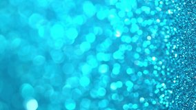 Blue Glitter Background. Magic holiday lights bokeh, shiny texture, flying particles form a beautiful bokeh. Shining festive Christmas backdrop. Vertical Video