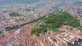 Inscription on video. Graz, Austria. The historic city center aerial view. Mount Schlossberg (Castle Hill). Knitted texture inscription, Aerial View, Departure of the camera